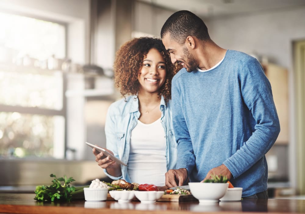 Resident couple cooking a meal together in their new home at Sofi Sunnyvale in Sunnyvale, California