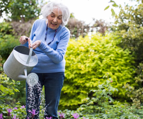 Resident watering plants in the garden at Governor's Port in Mentor, Ohio