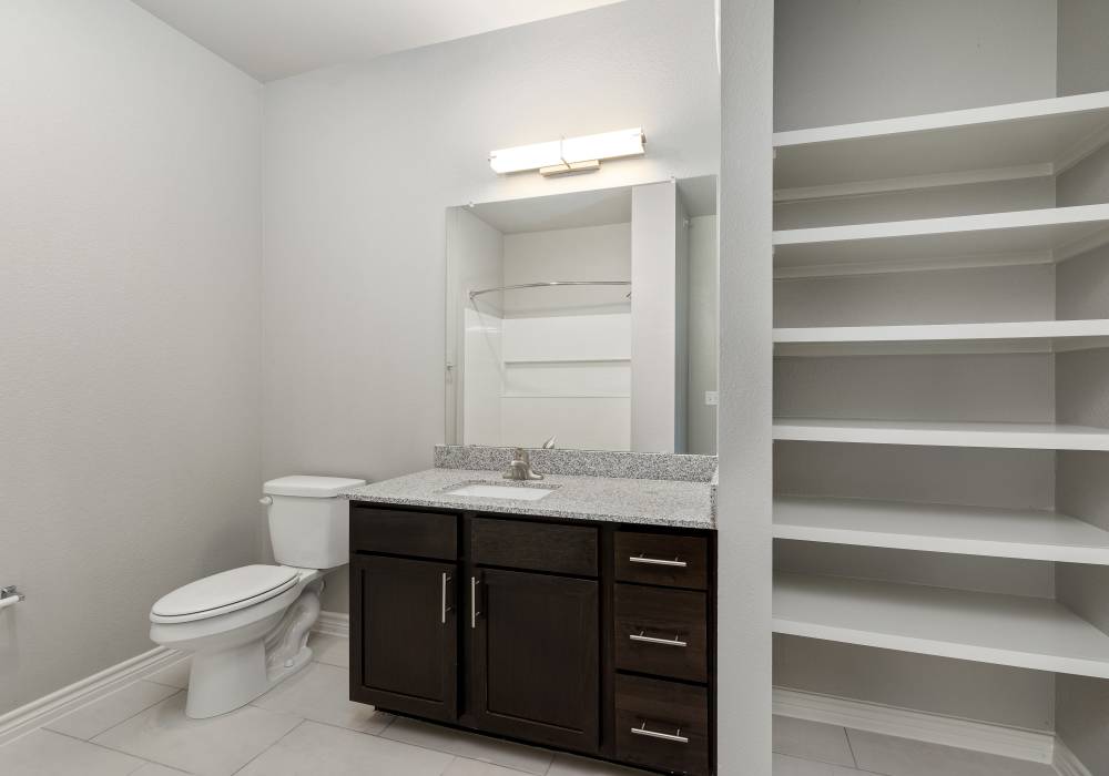 Bathroom with storage units at Preserve at Gresham Lake in Raleigh, North Carolina
