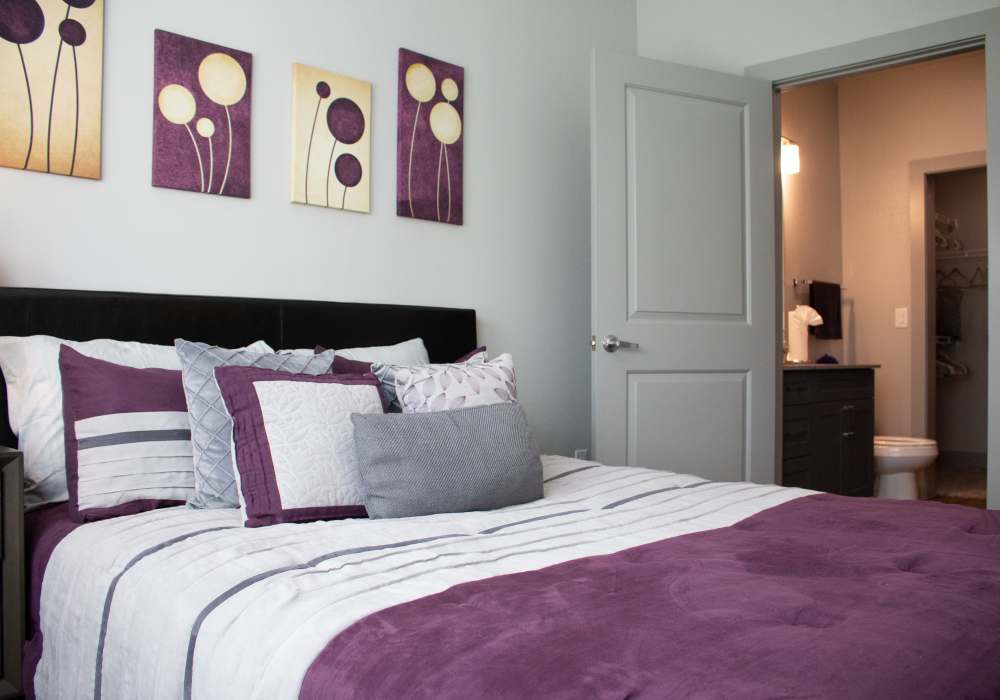 Model bedroom with violet bedsheet at The Bammel in Houston, Texas