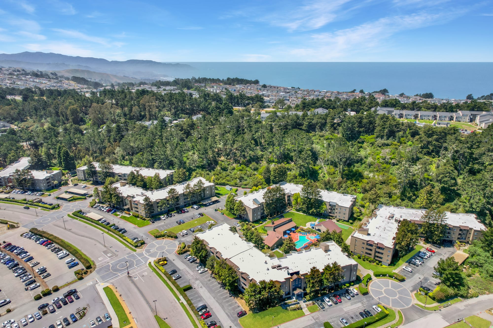 Aerial View of Property and the Pacific Ocean at Serramonte Ridge Apartment Homes in Daly City, California