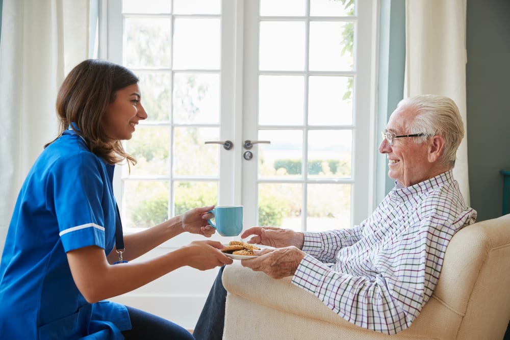 Staff brings resident a snack at Arbor View in Burlington, Wisconsin.