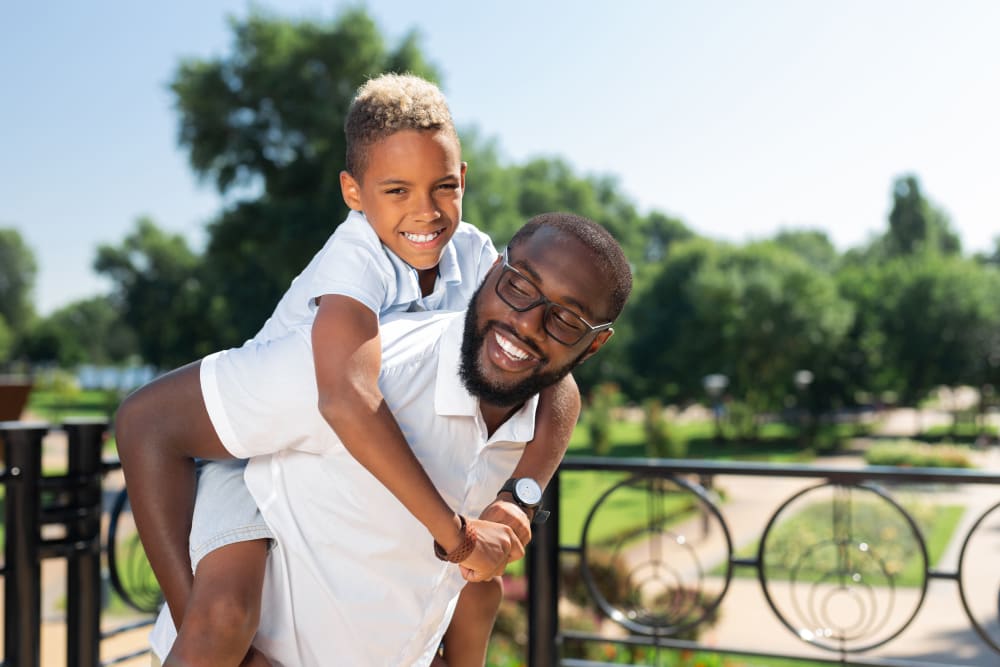 Father and son at park nearThe Fountains of Preston Hollow in Dallas, Texas