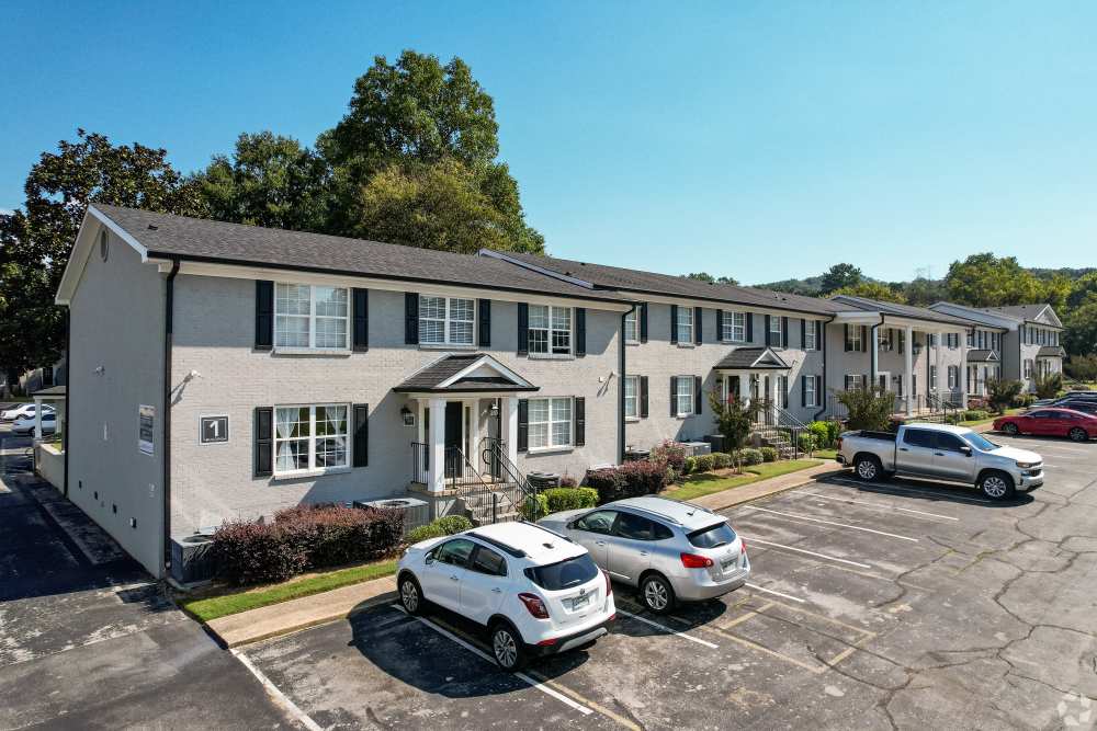 Community apartment with cars parked at Midtown Square Chattanooga Apartments in Chattanooga, Tennessee