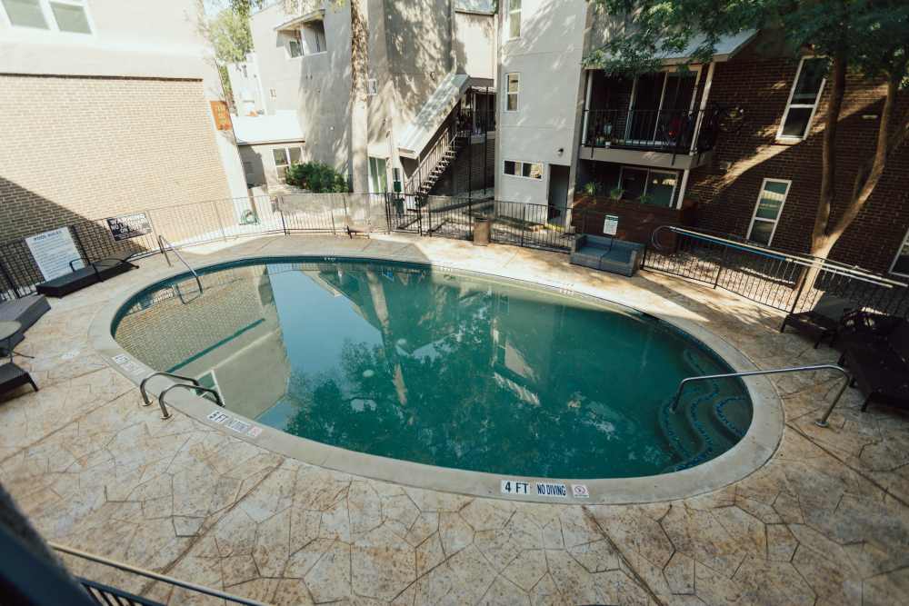 Charming swimming pool with inviting lounge areas at San Mateo Forest in Dallas, Texas.