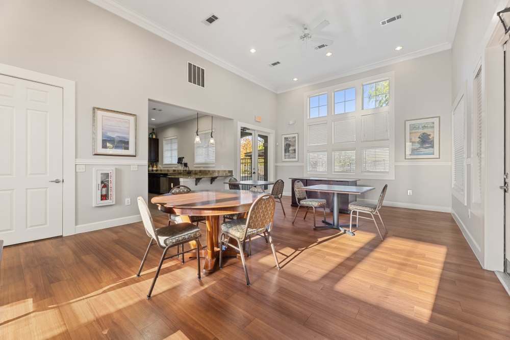 A view of the community room with tables and chairs at Costa Ibiza in Houston, Texas