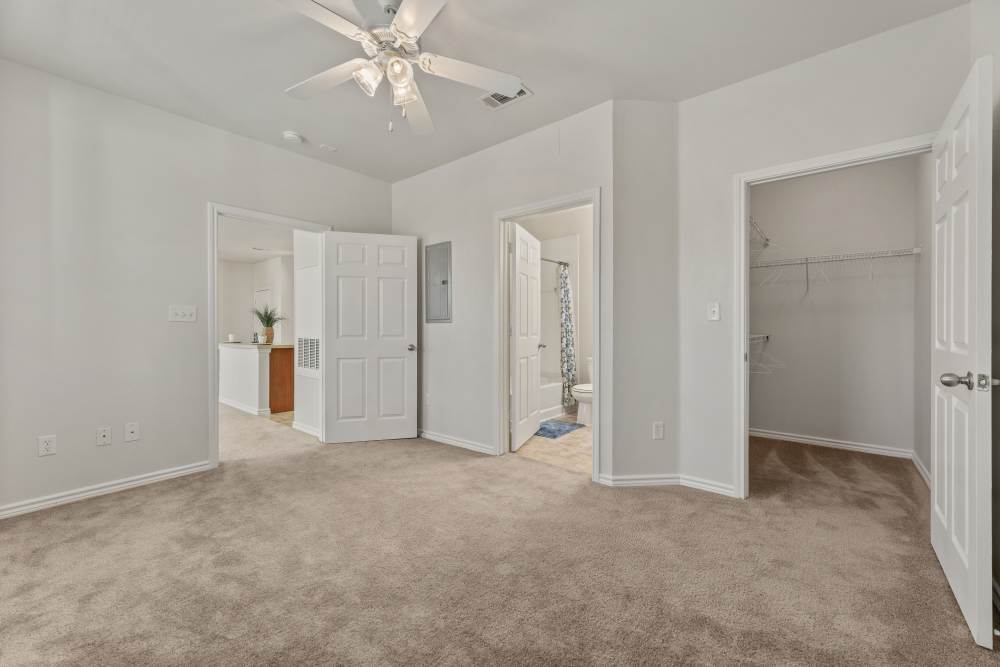 A view of the bedroom with a spacious walk-in closet at Costa Ibiza in Houston, Texas