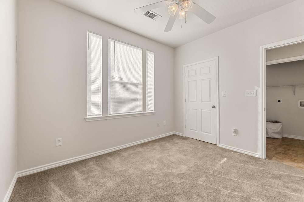 Unfurnished bedroom with walk-in closet at Costa Ibiza in Houston, Texas