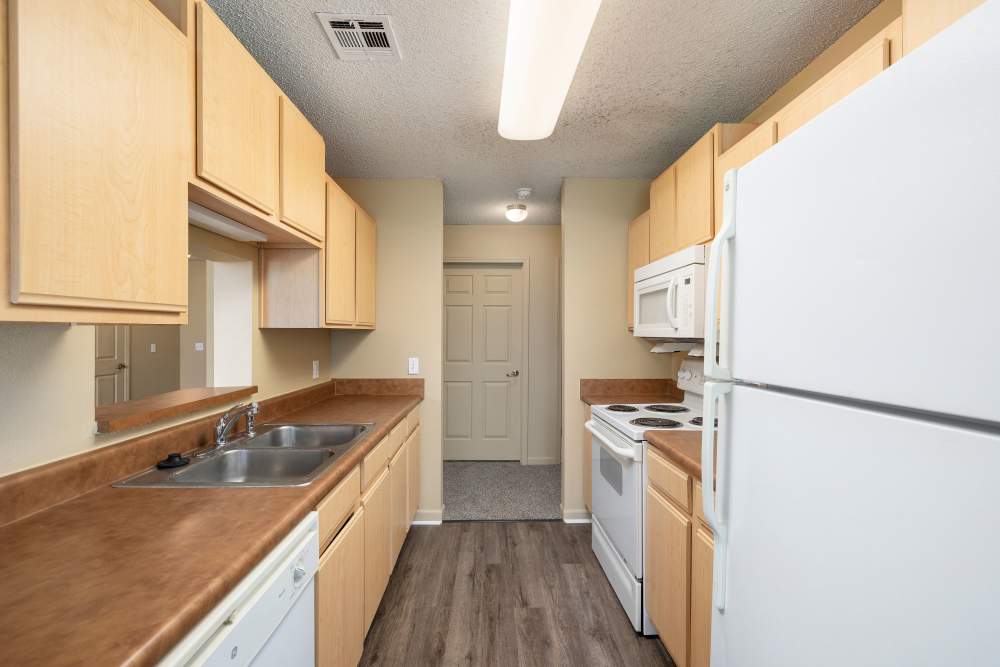 Kitchen with wood flooring at Prairie Hill Estates in Carl Junction. MO