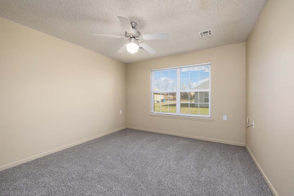 Spacious bedroom with window at Prairie Hill Estates in Carl Junction. MO