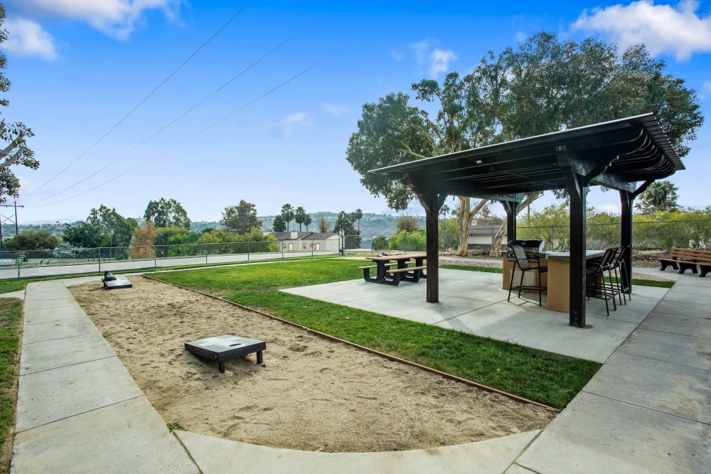 Corn hole and covered grills at Shadow Ridge Apartments in Oceanside, California