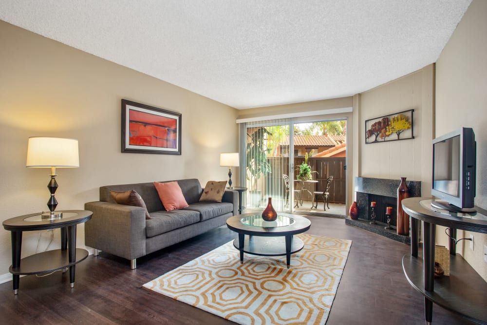 Living room with hardwood-style flooring at Shadow Ridge Apartments in Oceanside, California