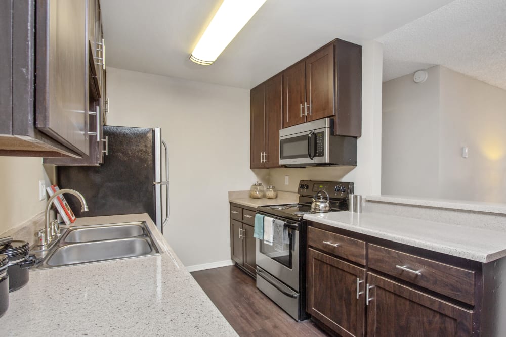 A kitchen with granite-style counter tops at Shadow Ridge Apartments in Oceanside, California