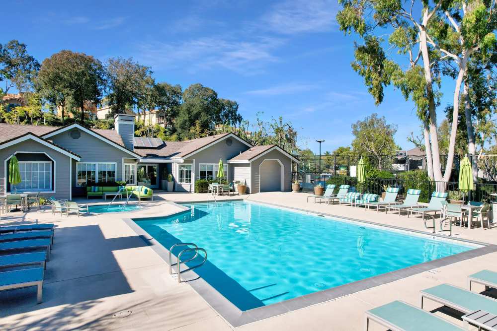 Swimming pool with sun loungers at Village Oaks in Chino Hills, California