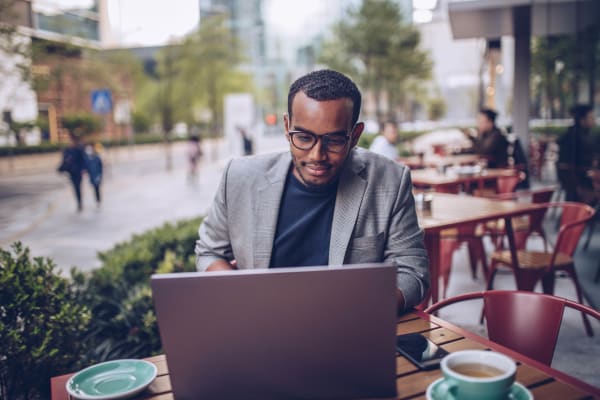 Resident working on his PhD manuscript at a cafe near Seventeen Mile Drive Village Apartment Homes in Pacific Grove, California