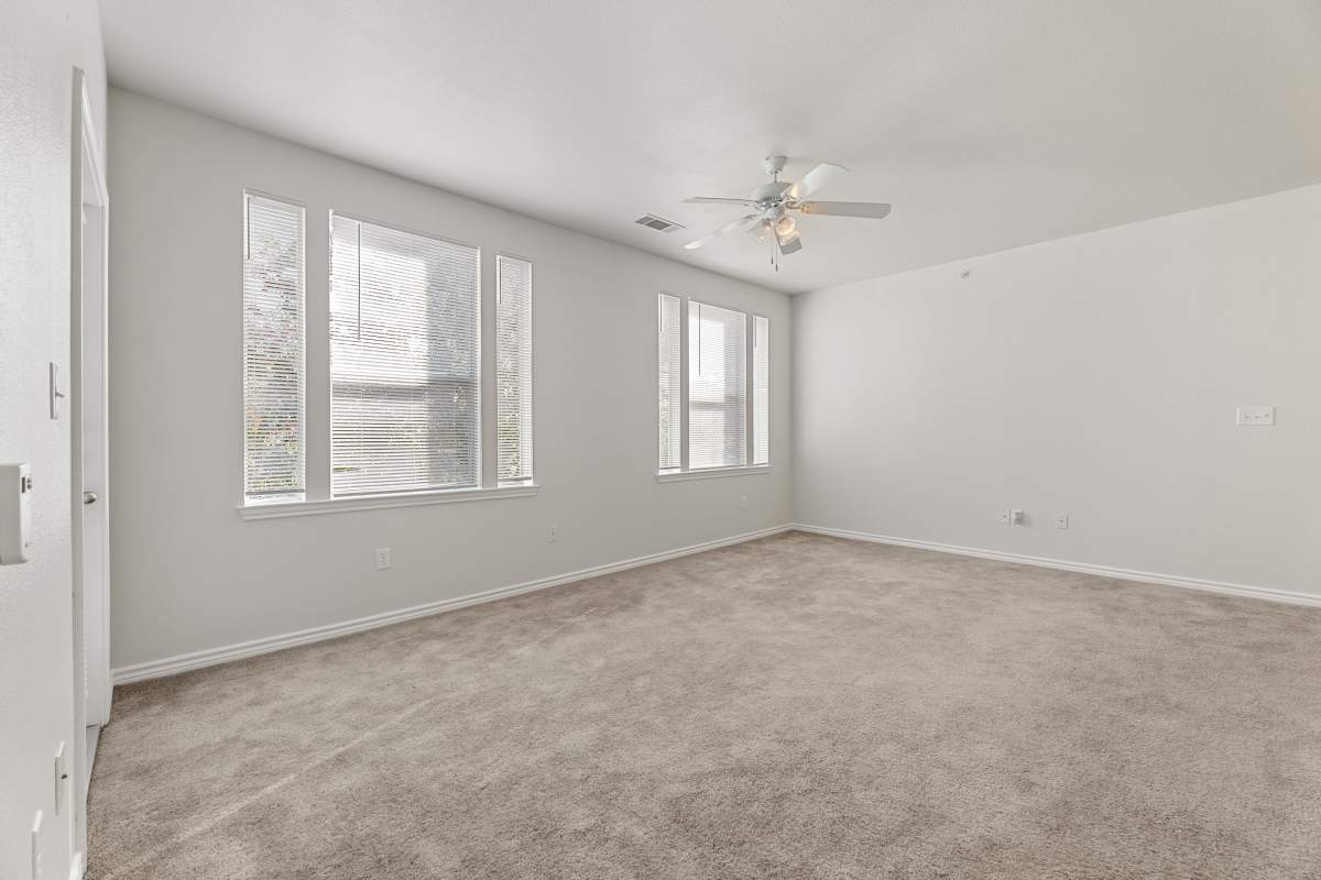 An unfurnished living room with ceiling fan at Costa Ibiza in Houston, Texas