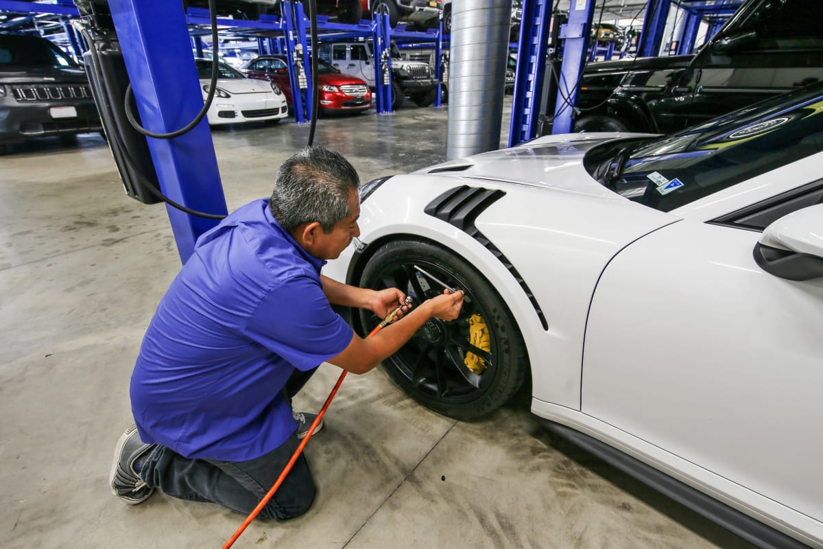 A technician maintains proper tire pressure on a Porsche at A-1 Car Storage in San Diego, California