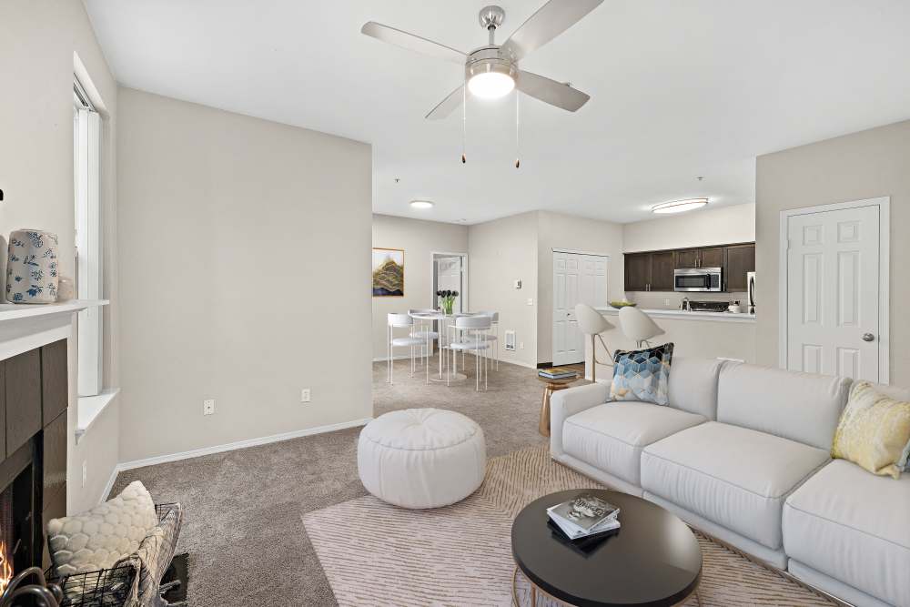 Living room with fireplace and view to kitchen at Wildreed Apartments in Everett, Washington