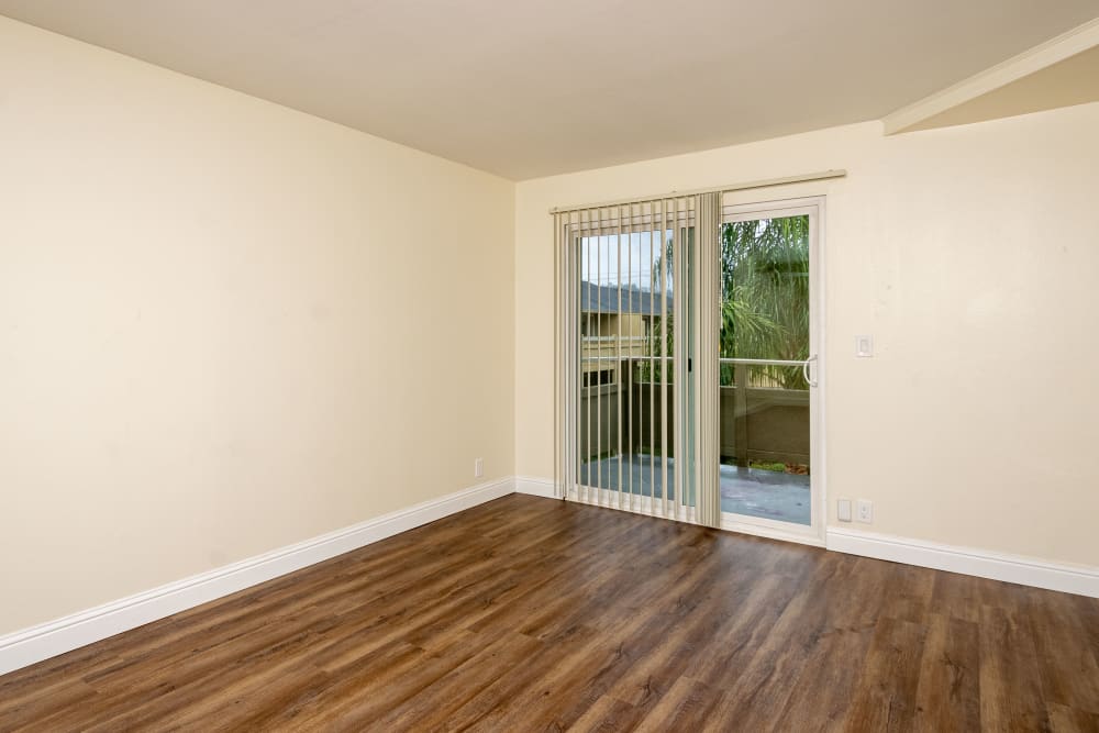 Living room with door to balcony at Bayfair Apartment Homes in San Lorenzo, California