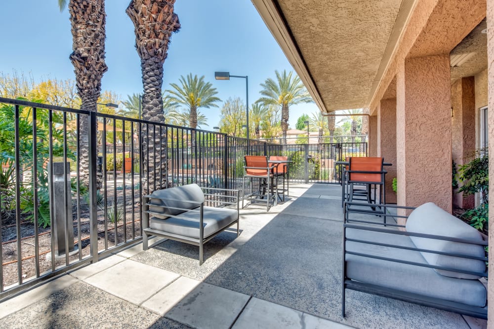 A sunny outdoor patio area at Tuscany Village Apartments in Ontario, California