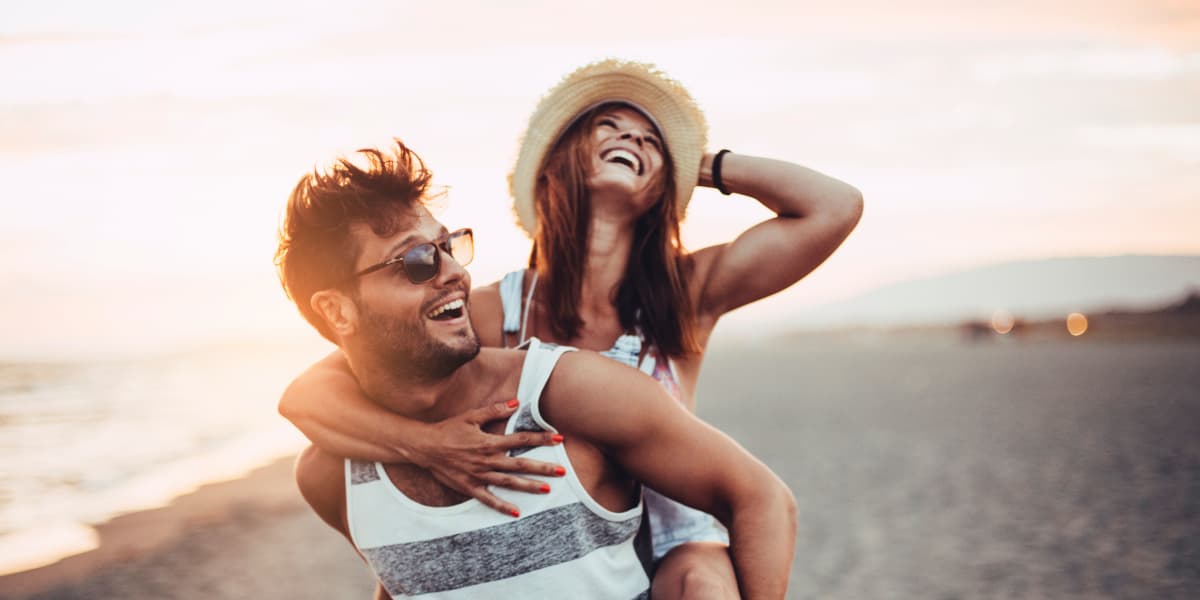 Young couple having fun on the beach near The Sophia at Abacoa in Jupiter, Florida