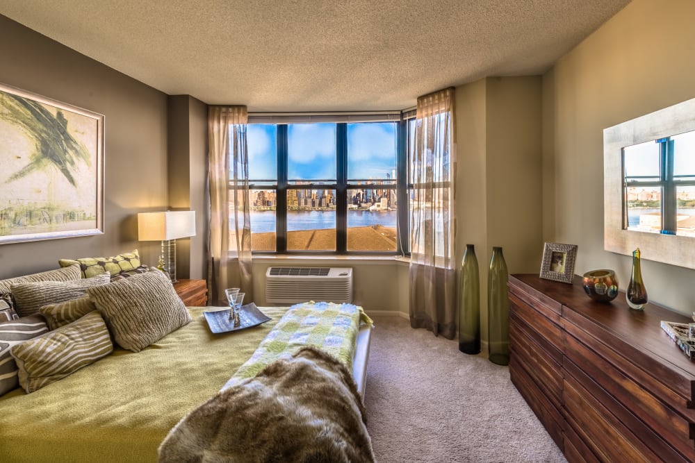 Model bedroom with beautiful views at Riverbend at Port Imperial in West New York, New Jersey