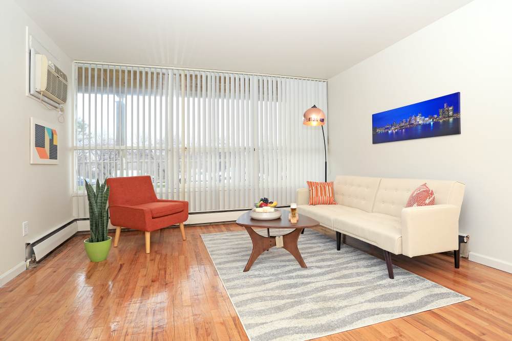 Open layout living room with hard-wood style flooring at Detroit Living in Detroit, Michigan