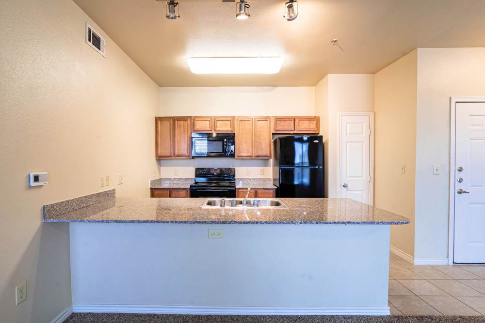Gourmet kitchen with granite countertops and stainless-steel appliances at Blue Ridge in Midland, Texas