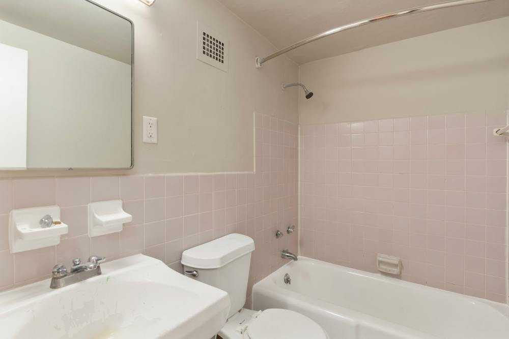Bathroom with a sleek design and white accents at Central Gardens in Memphis, Tennessee