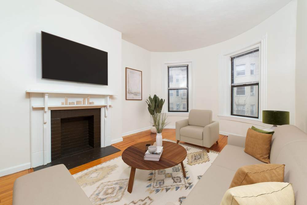 Garden style round coffee table with decorative items at 15-25 Hemenway Apartments in Boston, Massachusetts
