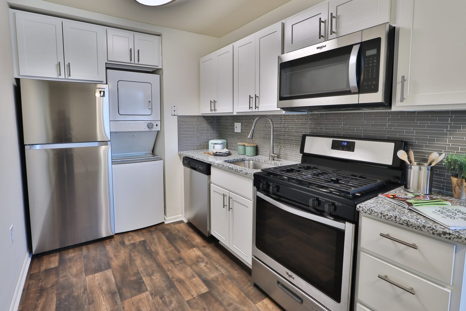 Modern kitchen with stainless-steel appliances and white cabinets at Eagle's Crest Apartments in Harrisburg, Pennsylvania