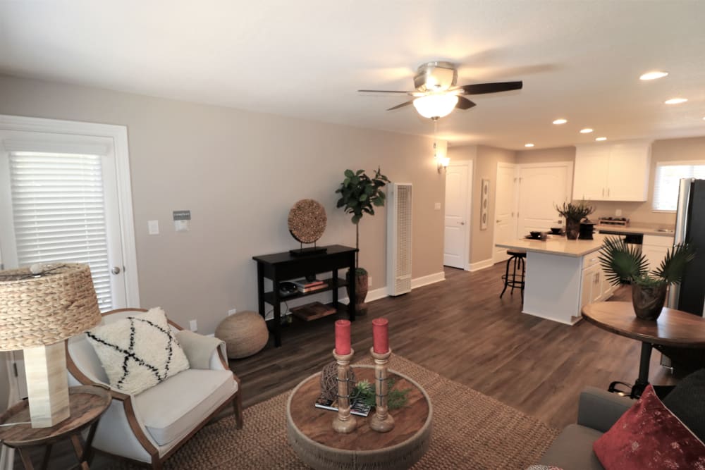 Model living room with wood-style flooring at Pinebrook Apartment Homes in Fremont, California