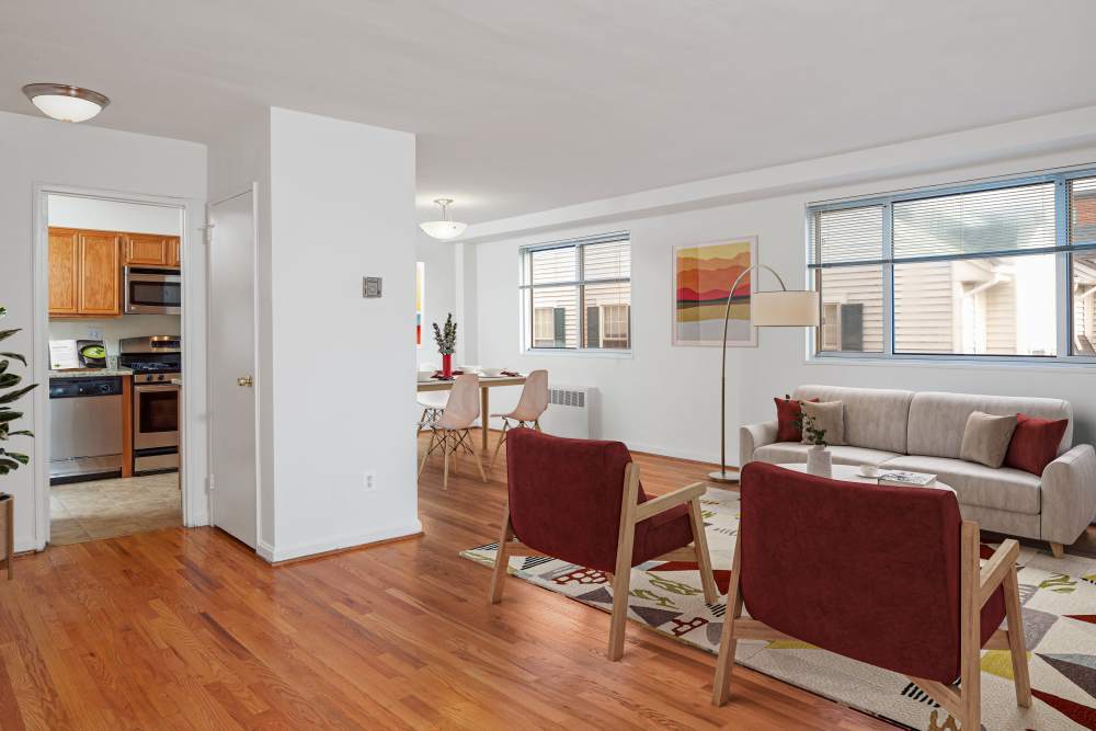 Living room with couches and connecting to kitchen at Bradley View Apartments in Chevy Chase, Maryland