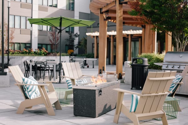 Comfortable seating and fire pit at outdoor common area at Grant Park Village