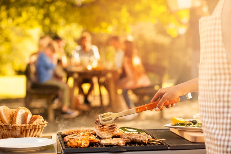 Friends grilling at Park Hudson Place in Bryan, Texas