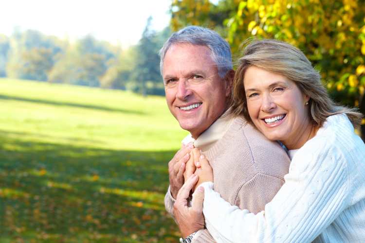 Senior couple smiling in nature at Watermere Highlands in Arlington, Texas
