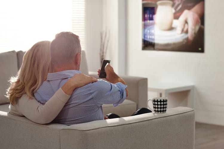 Couple watching tv at their living room at The Nathaniel in Rochester, New York