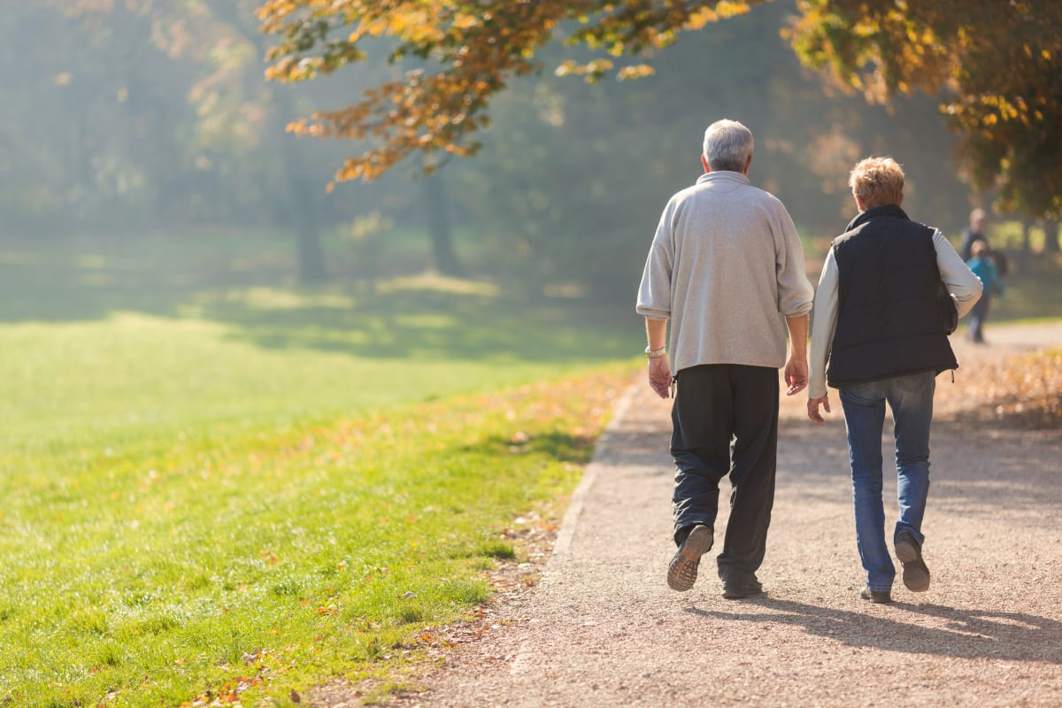 Resident couple walking outside on a dirt path near Citrus Place in Riverside, California