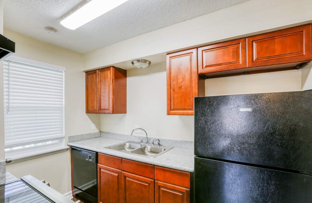 Wooden cabinets and stanless-steel appliances at Creekwood Townhomes in Hammond, Louisiana