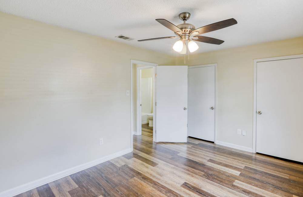 Bedroom with ceiling fan at Creekwood Townhomes in Hammond, Louisiana