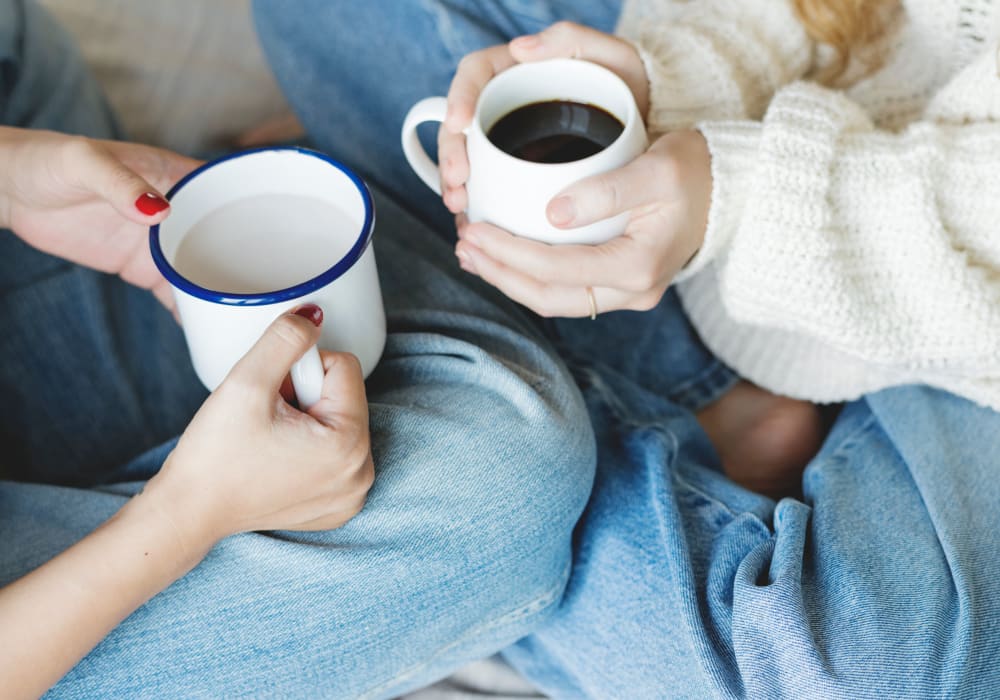 Residents chatting over coffee in their new home at Sofi at 50 Forest in Stamford, Connecticut