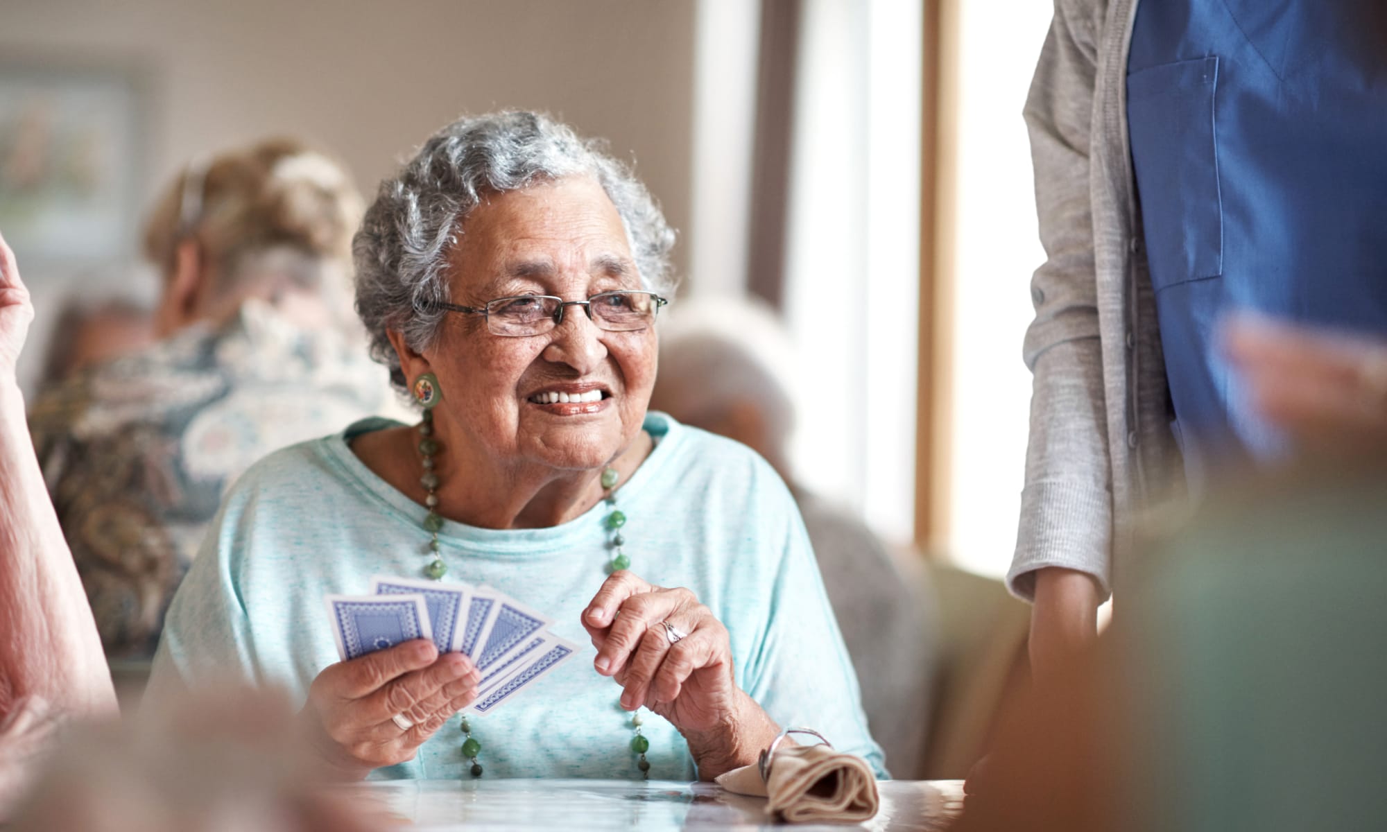 Resident playing cards at a Retirement Center Management community