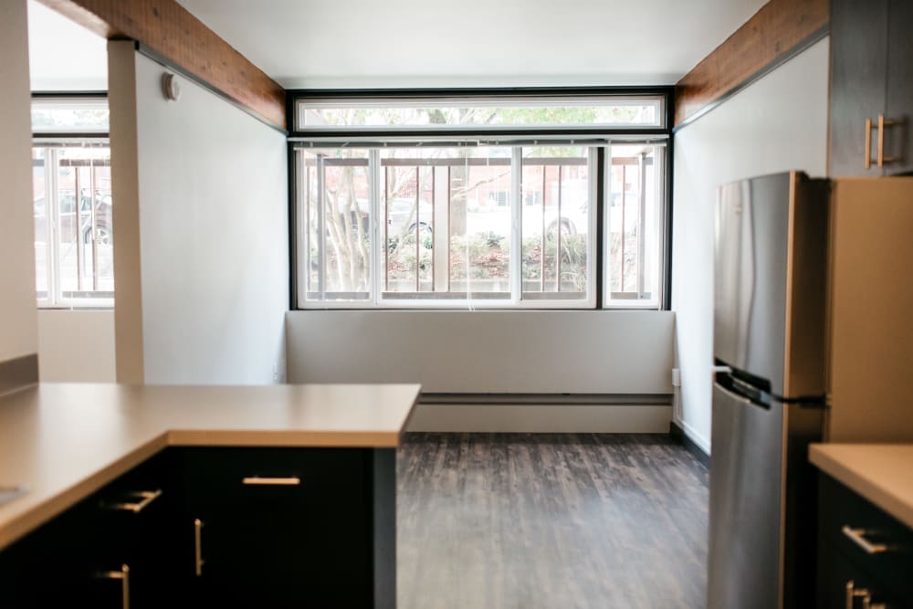 View of a large window and dining area from the kitchen at MOD Apartments in Seattle, Washington