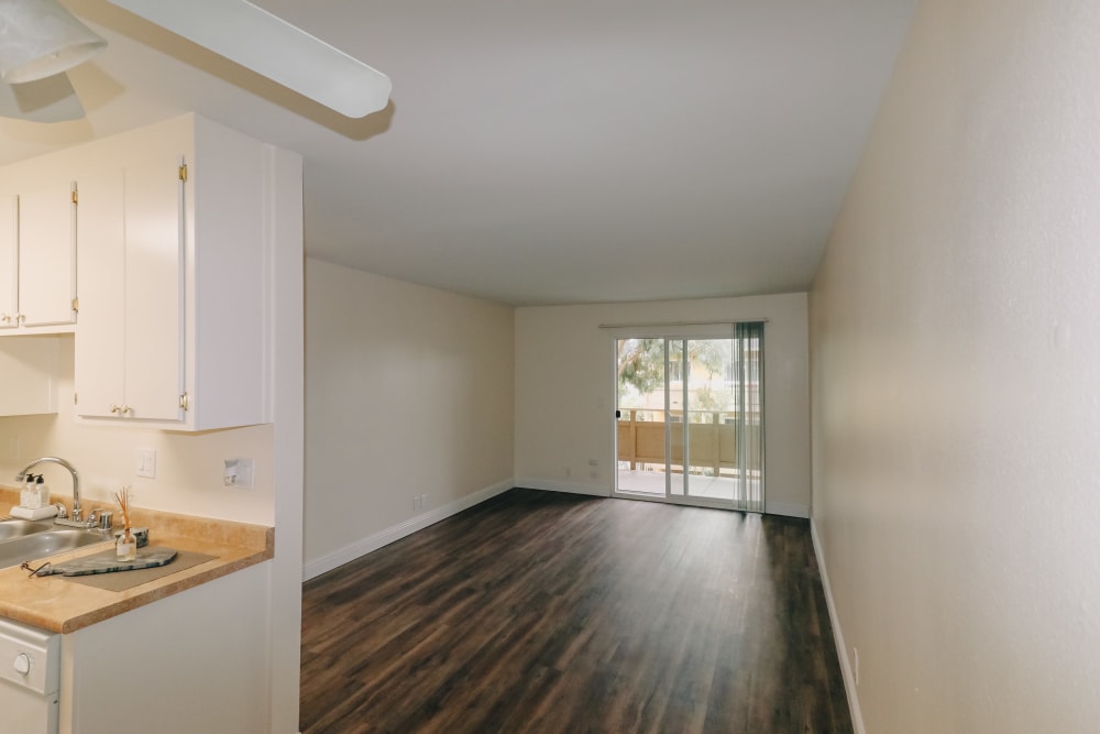 Living room with wood-style flooring at Bayfair Apartment Homes in San Lorenzo, California