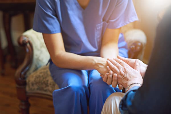 A Arbor Oaks Senior Living nurse comforting a resident