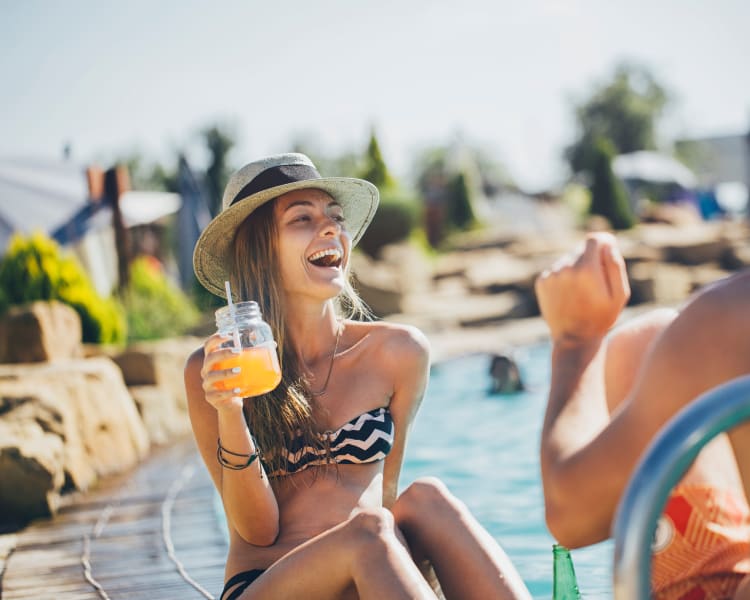 Resident enjoying a sunny day by the pool at Haven Martinez in Martinez, California