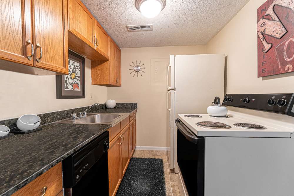 Kitchen with tile flooring and cabinetry at Tiger Village in Columbia, Missouri