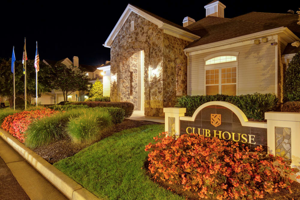 Sign outside of the clubhouse at night at Windsor Commons Apartments in Baltimore, Maryland