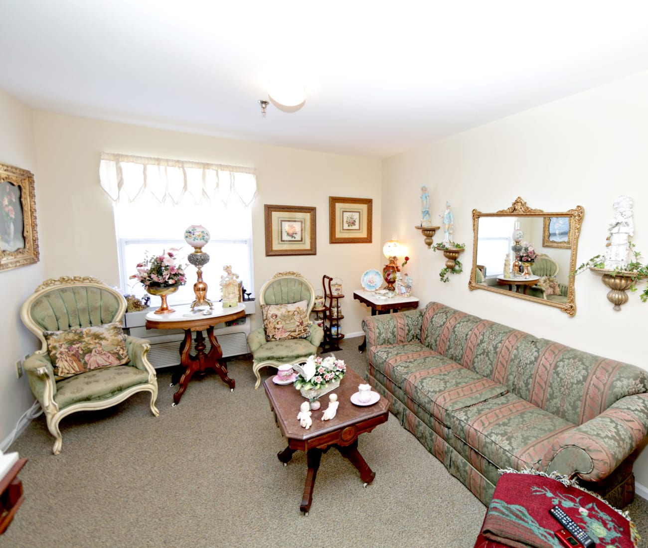 Resident living room with carpet and natural light at Providence Assisted Living in Senatobia, Mississippi