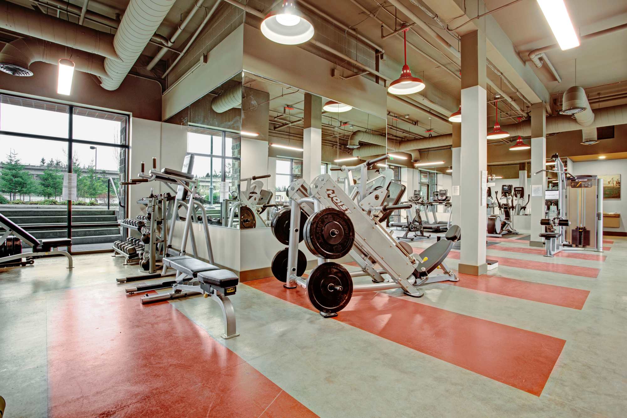 Fitness center with weight machine at Trax at Dupont Station in Dupont, Washington